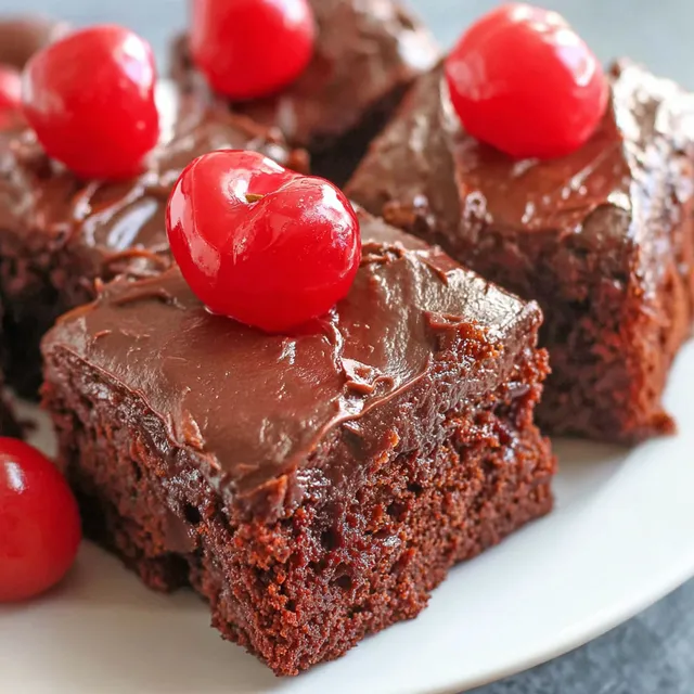 Chocolate cherry bars on a white plate.