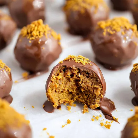 Gingersnap truffles on a white surface.