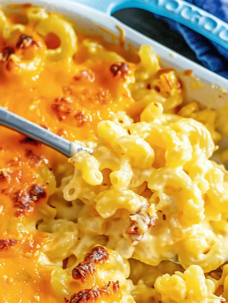 A fork is stuck in a baked mac and cheese dish.