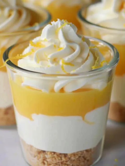 A glass of lemon parfait with whipped cream.