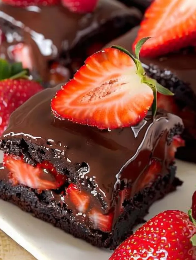 A close up of a chocolate covered strawberry brownie.