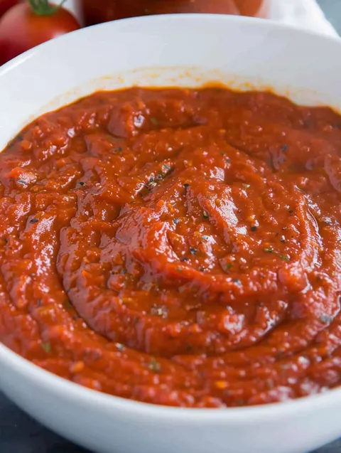 A bowl of red sauce.