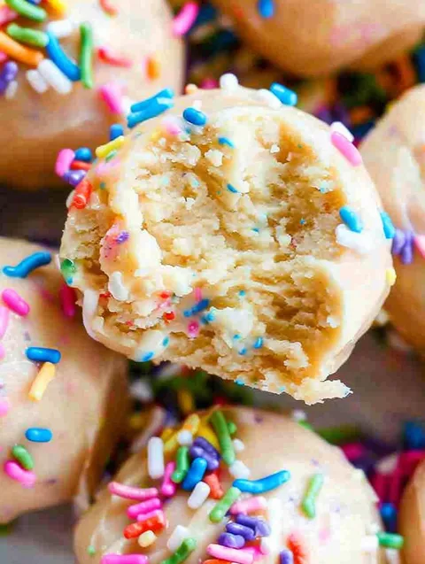 A close up of a cake with sprinkles.